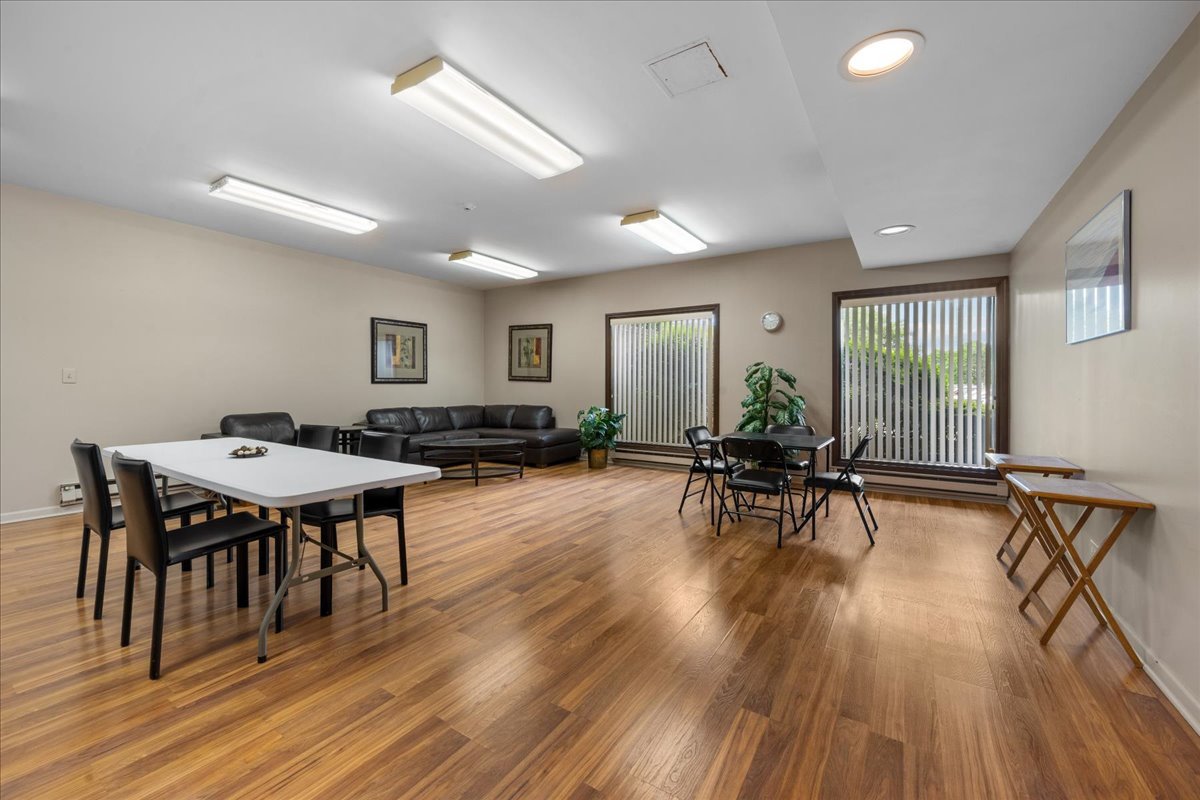 1795 Lake Cook Road, Unit 107 Highland Park, IL 60035 - Photo 24 of 26 a living room with furniture a wooden floor and a window