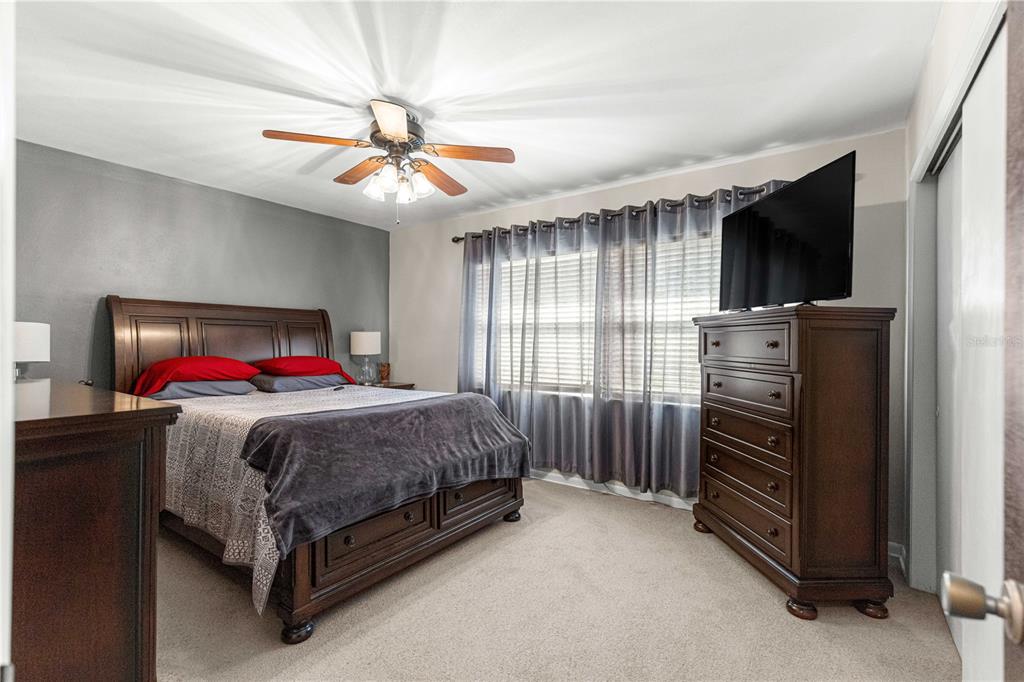 6401 East Holly Street Inverness, FL 34452 - Photo 17 of 51 a bedroom with a bed and a chandelier