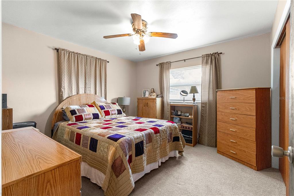 6401 East Holly Street Inverness, FL 34452 - Photo 19 of 51 a bedroom with a bed and a chandelier