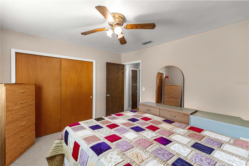 6401 East Holly Street Inverness, FL 34452 - Photo 20 of 51 a bedroom with a bed and a mirror