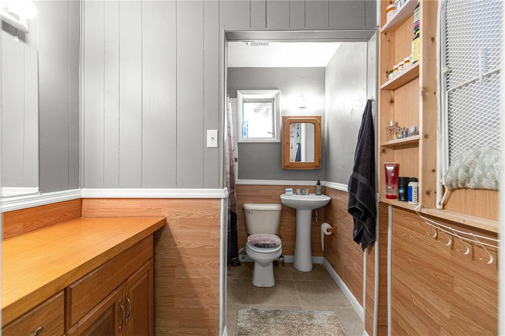 6401 East Holly Street Inverness, FL 34452 - Photo 21 of 51 a bathroom with a sink a toilet and shower