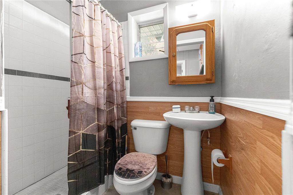 6401 East Holly Street Inverness, FL 34452 - Photo 22 of 51 a bathroom with a sink a toilet and a mirror