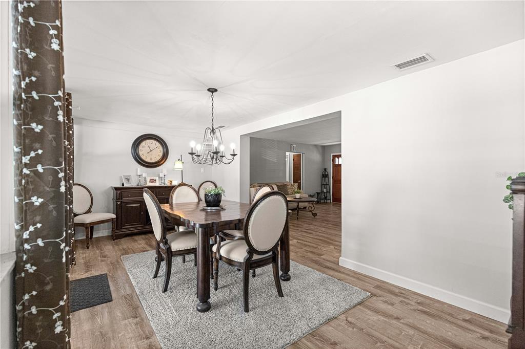 6401 East Holly Street Inverness, FL 34452 - Photo 26 of 51 a dining room with furniture a chandelier and wooden floor