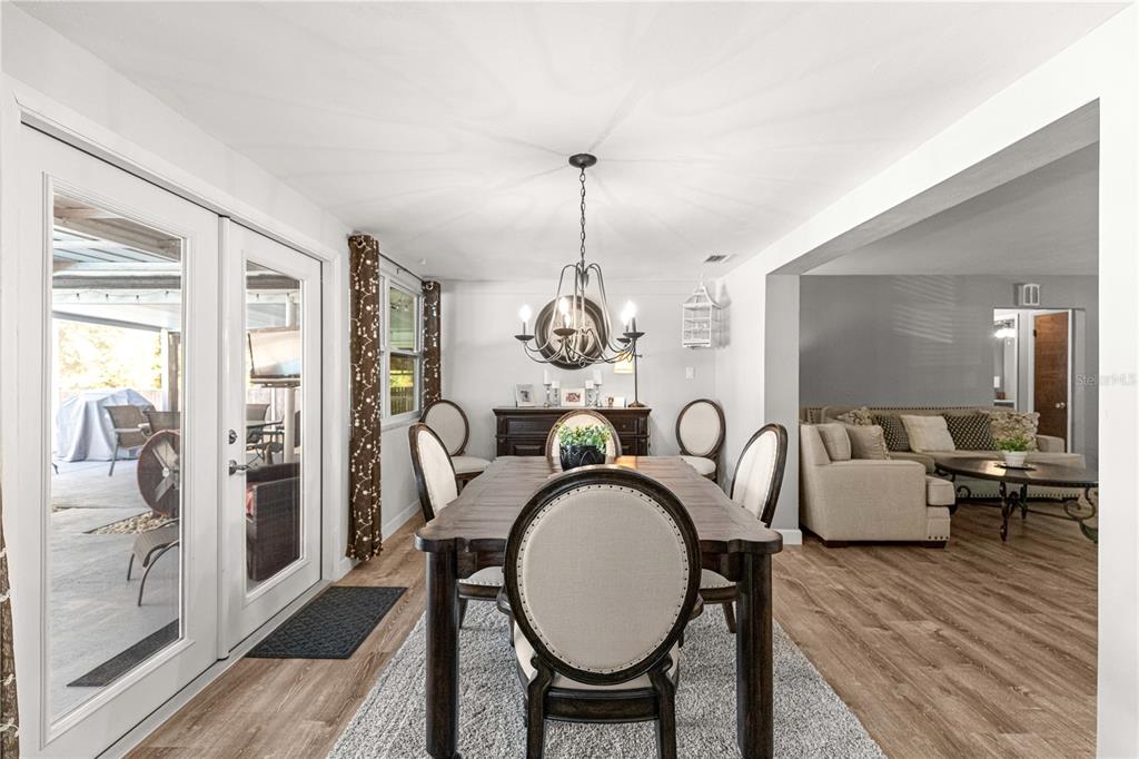 6401 East Holly Street Inverness, FL 34452 - Photo 27 of 51 a dining room with furniture a chandelier and wooden floor