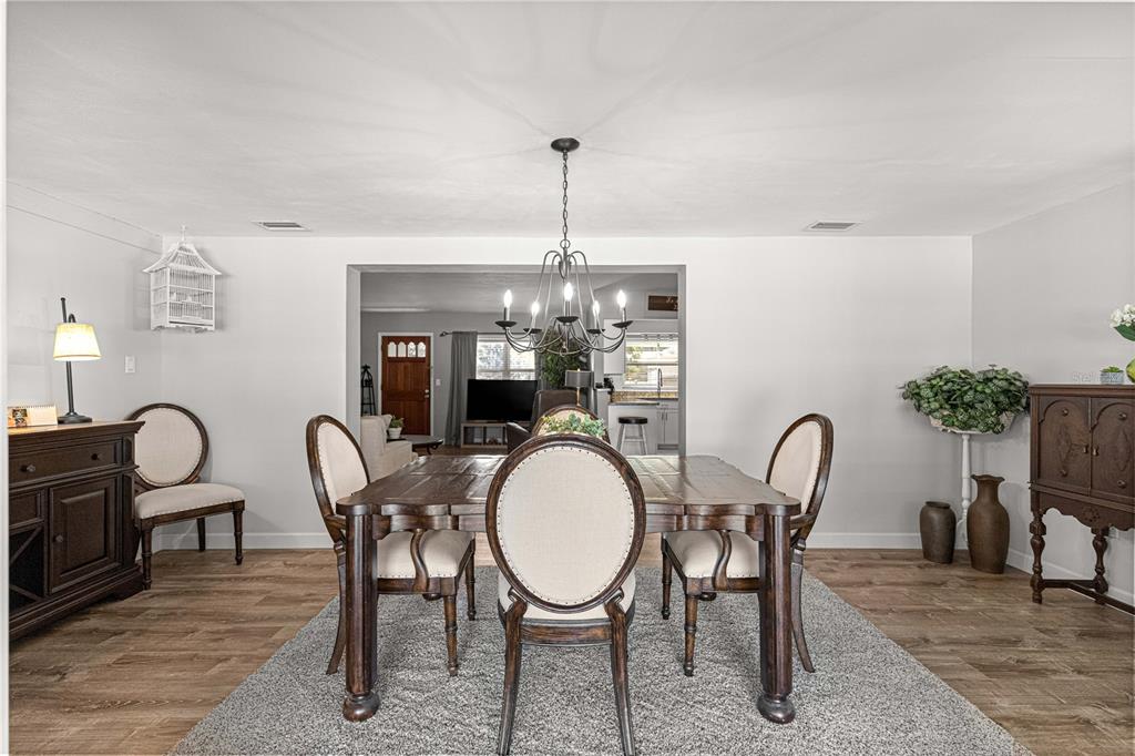 6401 East Holly Street Inverness, FL 34452 - Photo 28 of 51 a dining room with furniture a potted plant and a chandelier