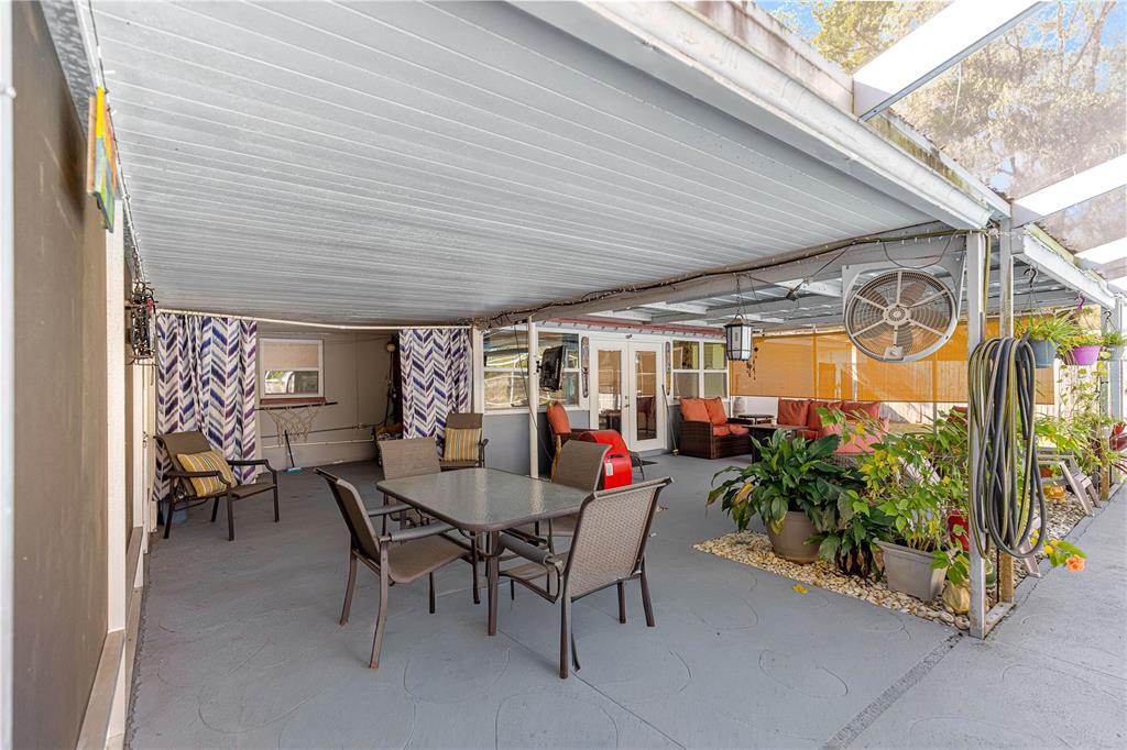 6401 East Holly Street Inverness, FL 34452 - Photo 31 of 51 a view of a patio with a table and chairs and potted plants