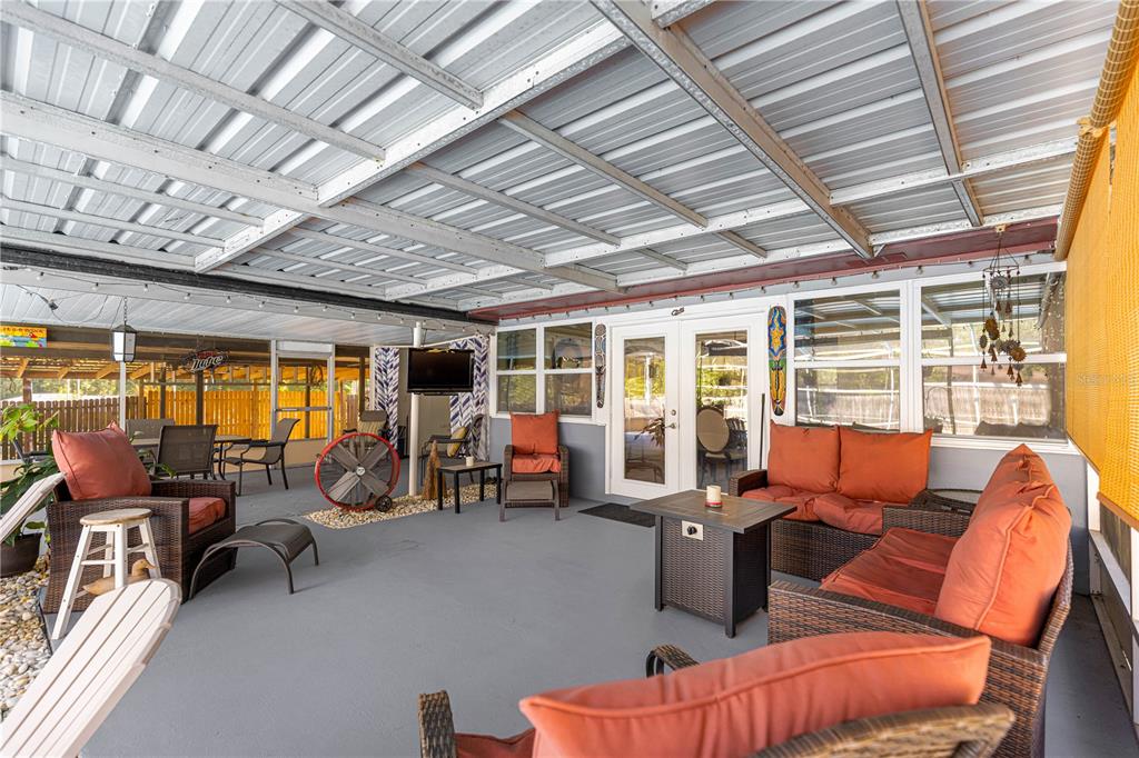 6401 East Holly Street Inverness, FL 34452 - Photo 33 of 51 a living room with furniture large windows and flat screen tv