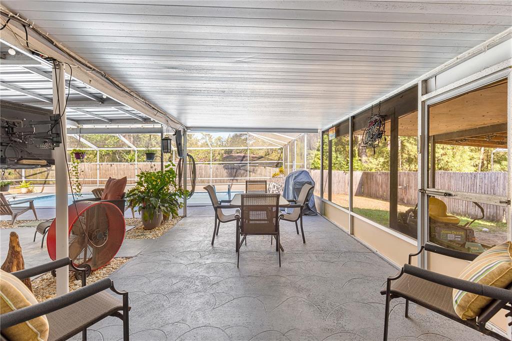 6401 East Holly Street Inverness, FL 34452 - Photo 36 of 51 a dining room with furniture and floor to ceiling window