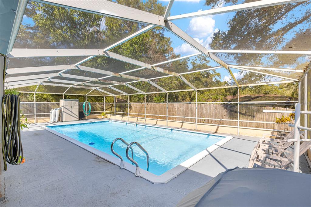 6401 East Holly Street Inverness, FL 34452 - Photo 38 of 51 a view of a swimming pool with a bench