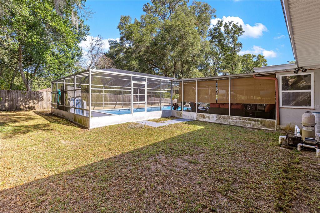 6401 East Holly Street Inverness, FL 34452 - Photo 42 of 51 a view of a backyard with wooden fence
