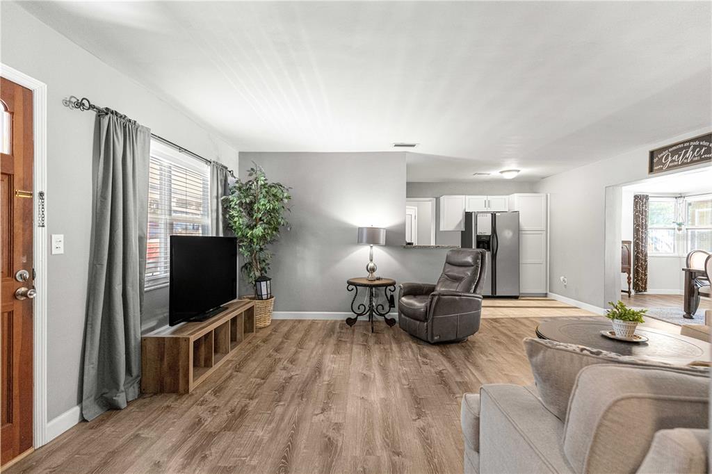 6401 East Holly Street Inverness, FL 34452 - Photo 9 of 51 a living room with furniture and a flat screen tv