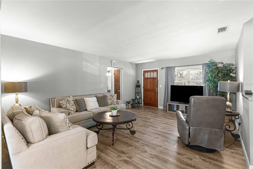 6401 East Holly Street Inverness, FL 34452 - Photo 10 of 51 a living room with furniture and a fireplace