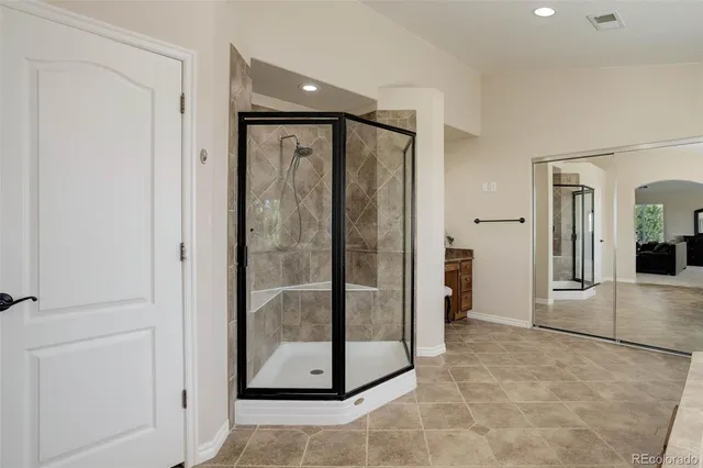 a view of a bathroom with a glass door shower