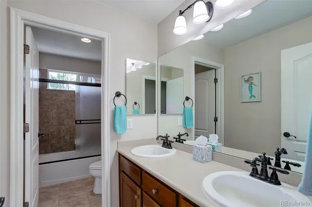 a bathroom with a sink vanity granite shower and a mirror