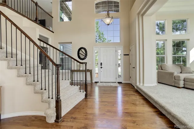 a view of an entryway with wooden floor and windows