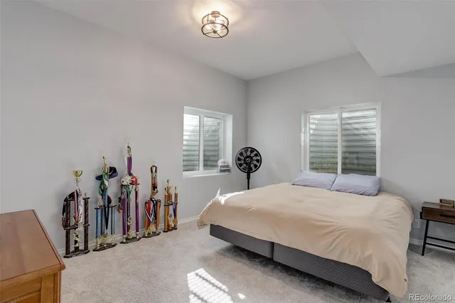 a bedroom with a bed and a large window