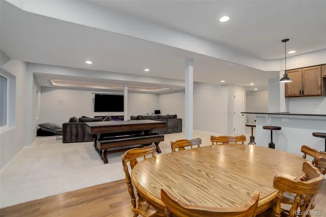 a room with furniture pool table flat screen tv and a sink