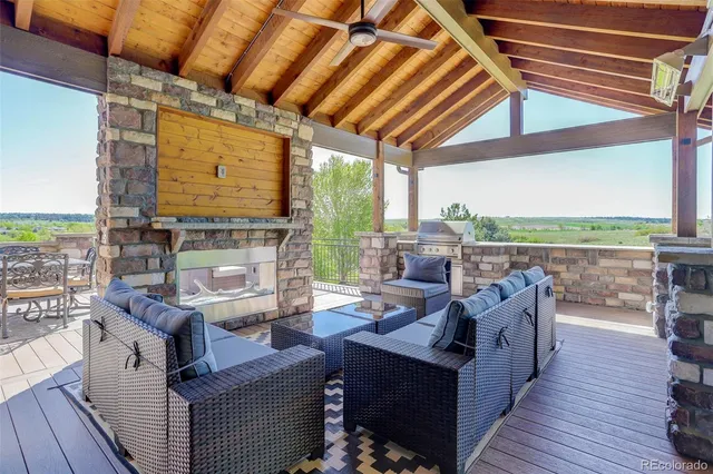 a living room with fireplace furniture and a floor to ceiling window
