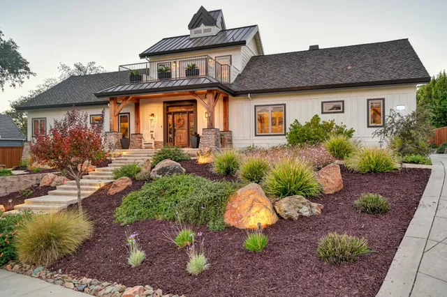 a front view of a house with garden