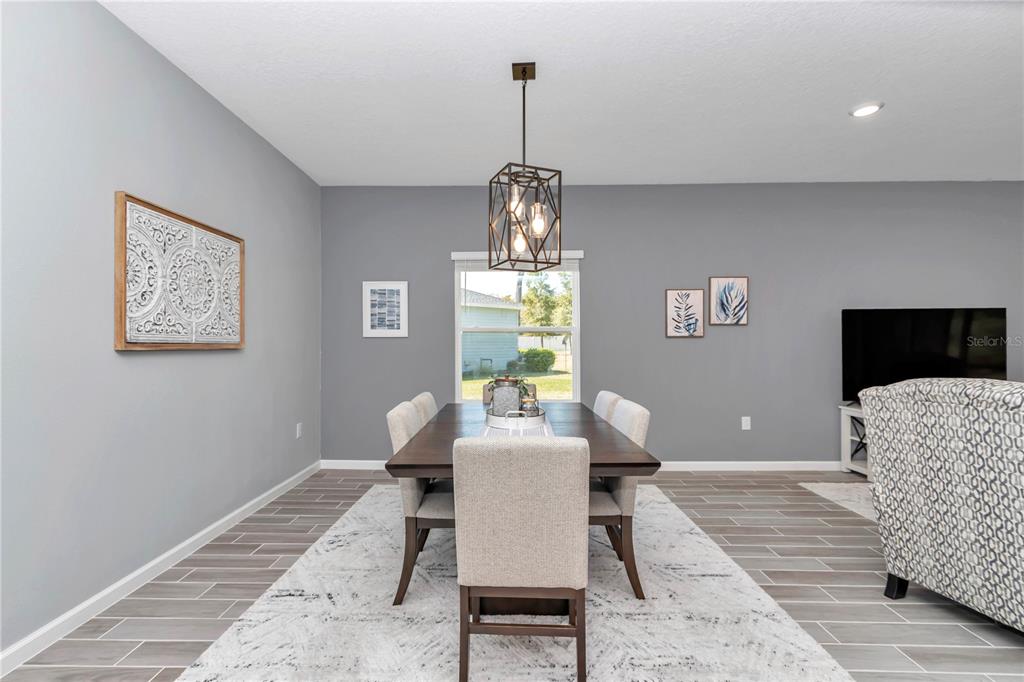 7651 Southwest 74th Loop Ocala, FL 34481 - Photo 11 of 47 a dining room with furniture and window