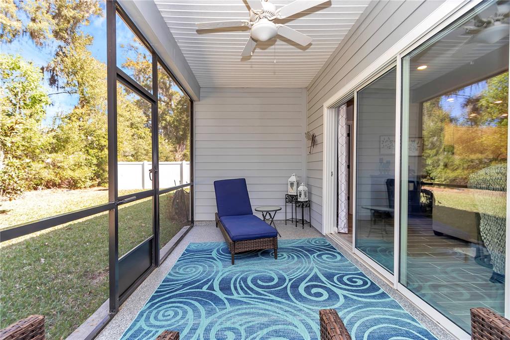 7651 Southwest 74th Loop Ocala, FL 34481 - Photo 30 of 47 a view of living room with furniture and a floor to ceiling window