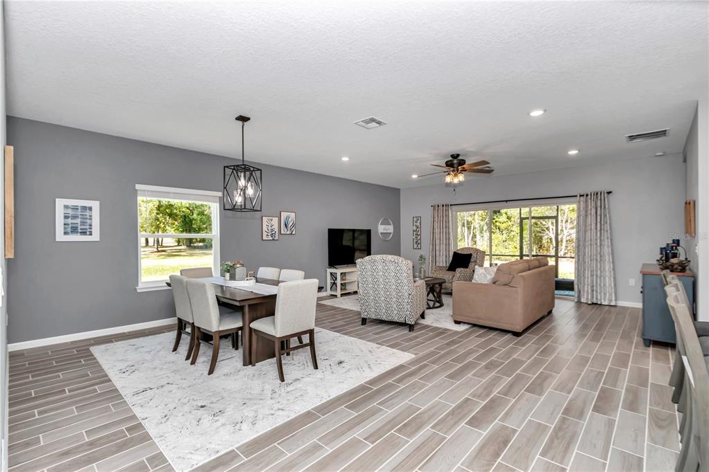 7651 Southwest 74th Loop Ocala, FL 34481 - Photo 3 of 47 a living room with furniture flat screen tv and a large window