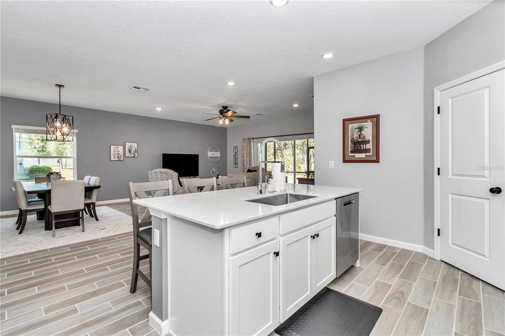 7651 Southwest 74th Loop Ocala, FL 34481 - Photo 37 of 47 an open kitchen with a sink cabinets and wooden floor