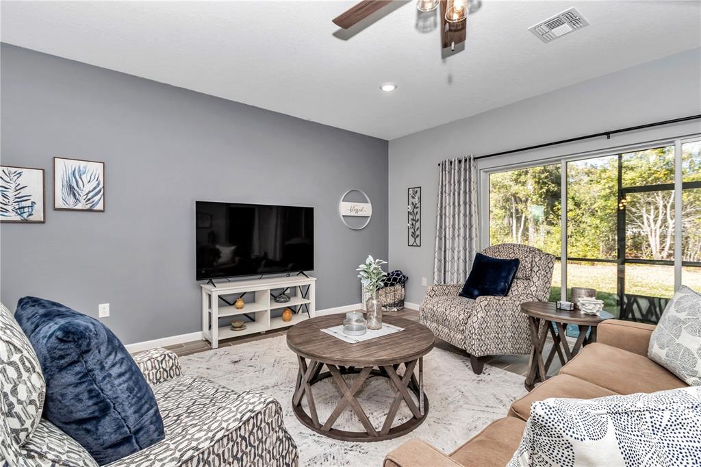 7651 Southwest 74th Loop Ocala, FL 34481 - Photo 41 of 47 a living room with furniture a flat screen tv and a large window