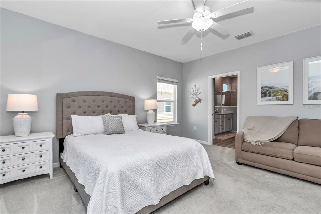 7651 Southwest 74th Loop Ocala, FL 34481 - Photo 7 of 47 a bedroom with a bed and ceiling fan