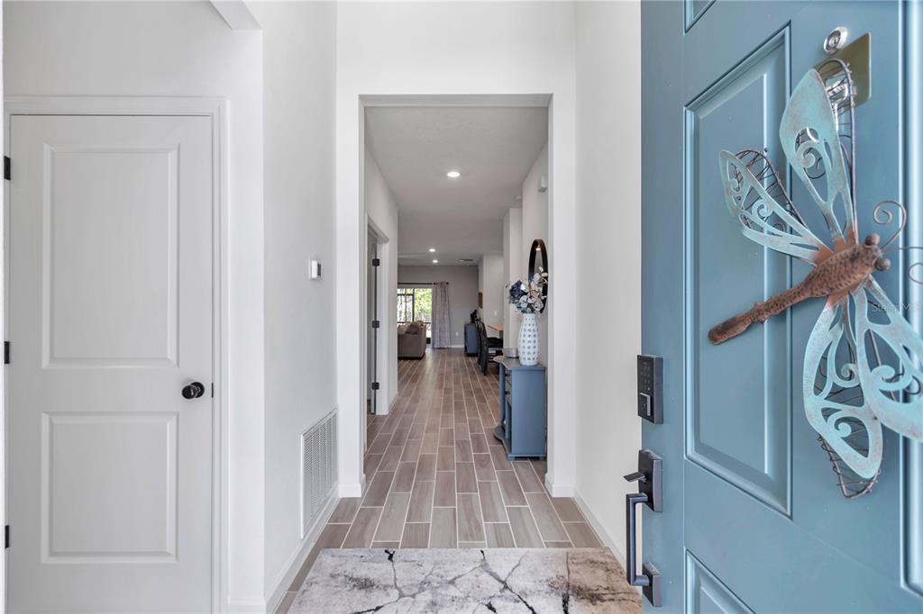 7651 Southwest 74th Loop Ocala, FL 34481 - Photo 9 of 47 a view of a hallway with wooden floor and entryway