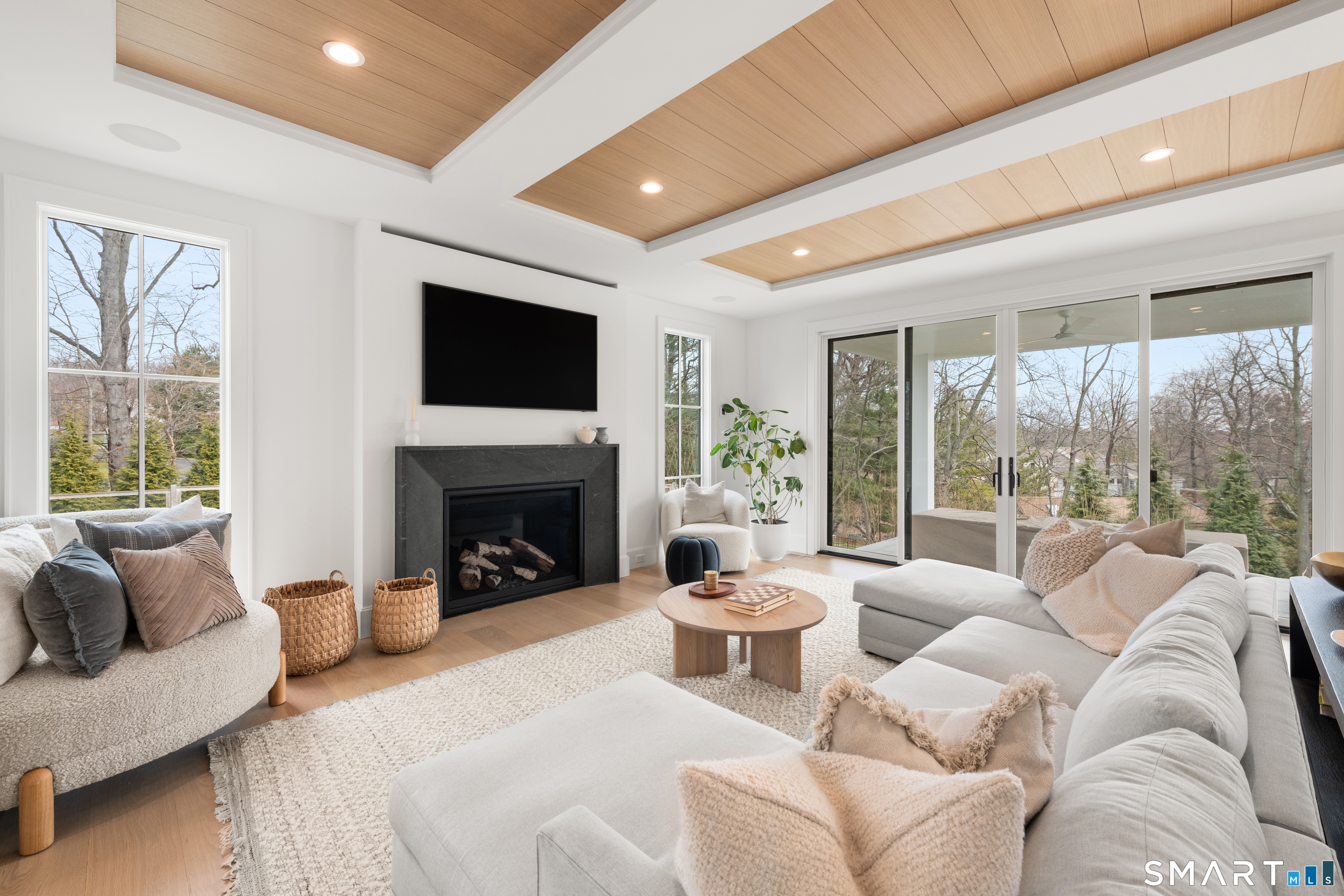 19 Mortar Rock Road Westport, CT 06880 - Photo 16 of 33 a living room with furniture a large window and a fireplace