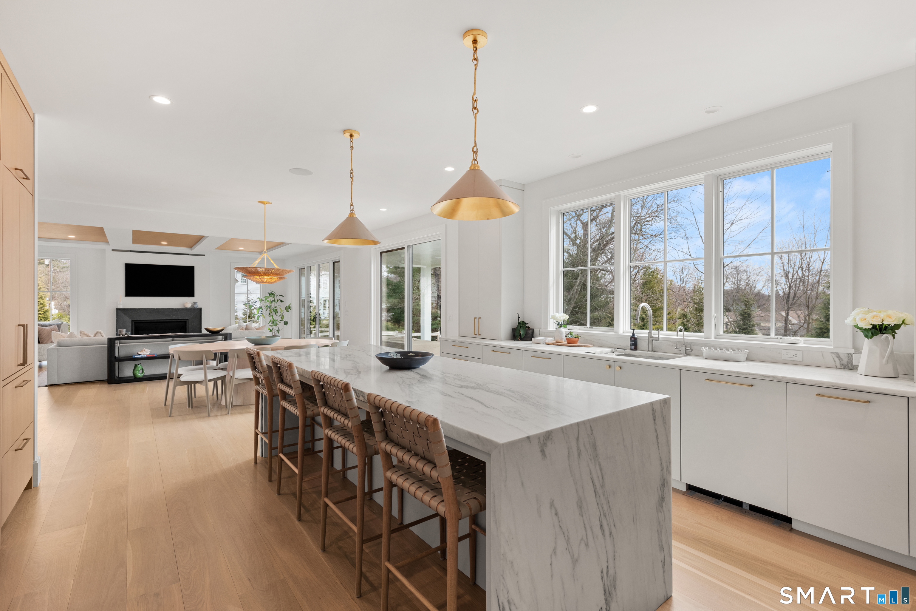 19 Mortar Rock Road Westport, CT 06880 - Photo 9 of 33 a kitchen with stainless steel appliances granite countertop a kitchen island a stove a sink a dining table and chairs with wooden floor