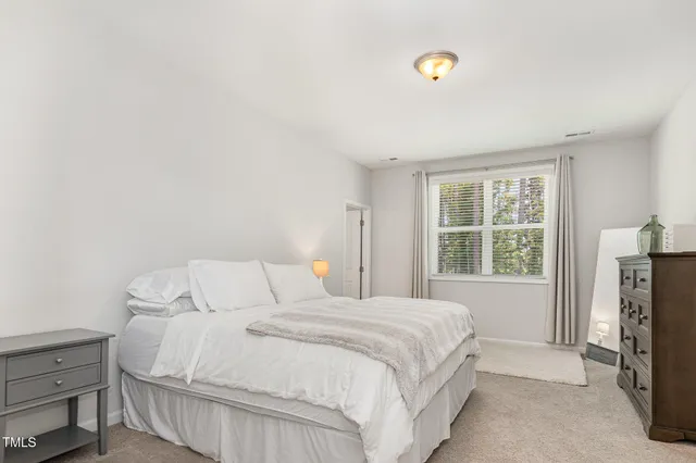 a view of a hallway to a livingroom with furniture and wooden floor