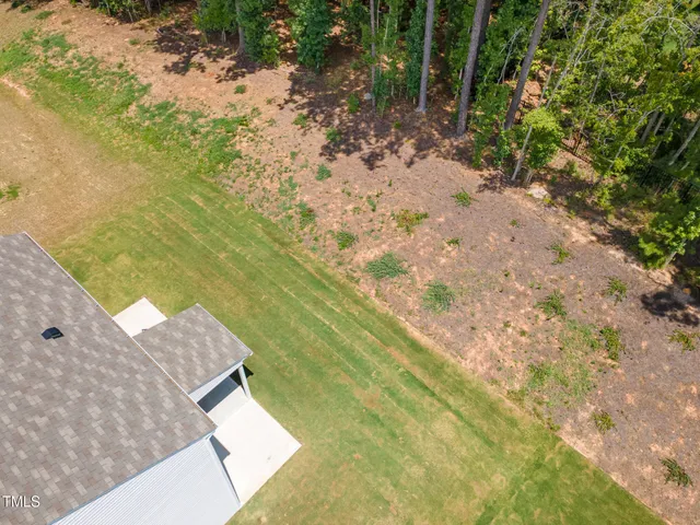 a front view of a house with a garden and patio
