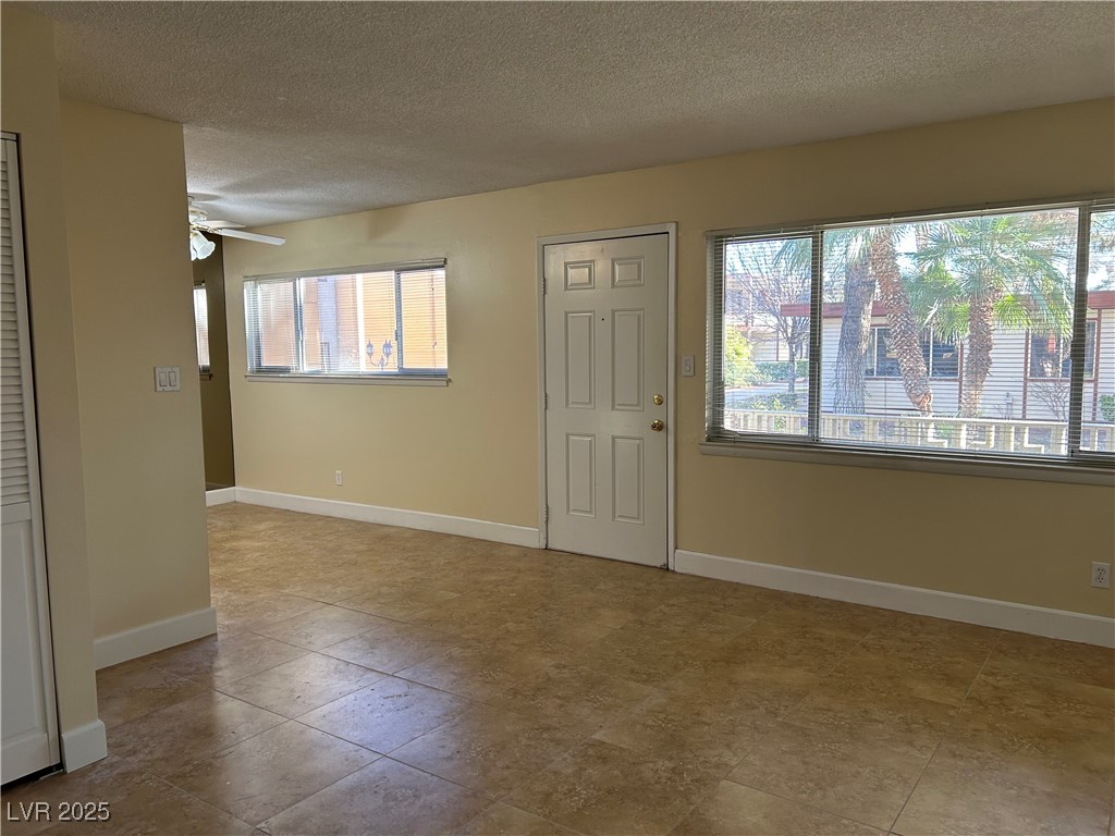 350 East Desert Inn Road, Unit F104 Las Vegas, NV 89109 - Photo 15 of 27 Entryway with a textured ceiling, healthy amount of natural light, and a ceiling fan