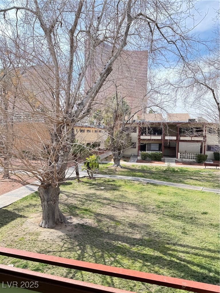 350 East Desert Inn Road, Unit F104 Las Vegas, NV 89109 - Photo 21 of 27 View of grassy yard with covered porch