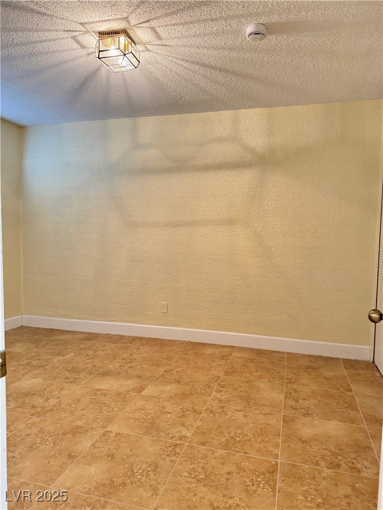 350 East Desert Inn Road, Unit F104 Las Vegas, NV 89109 - Photo 9 of 27 Empty room with a textured ceiling