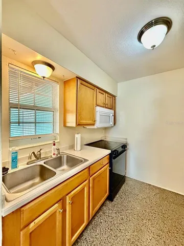 a kitchen that has a sink and a stove
