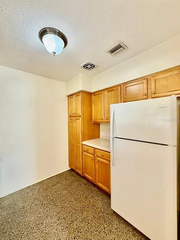 a white refrigerator freezer and a dishwasher sitting in a kitchen