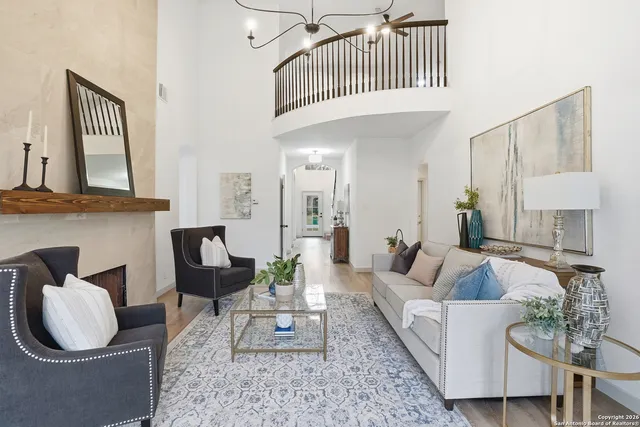 a living room with furniture a rug and a window