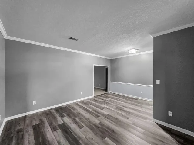 a view of room with wooden floor