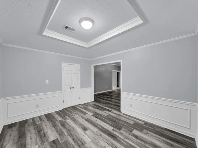 a view of a livingroom with wooden floor and staircase