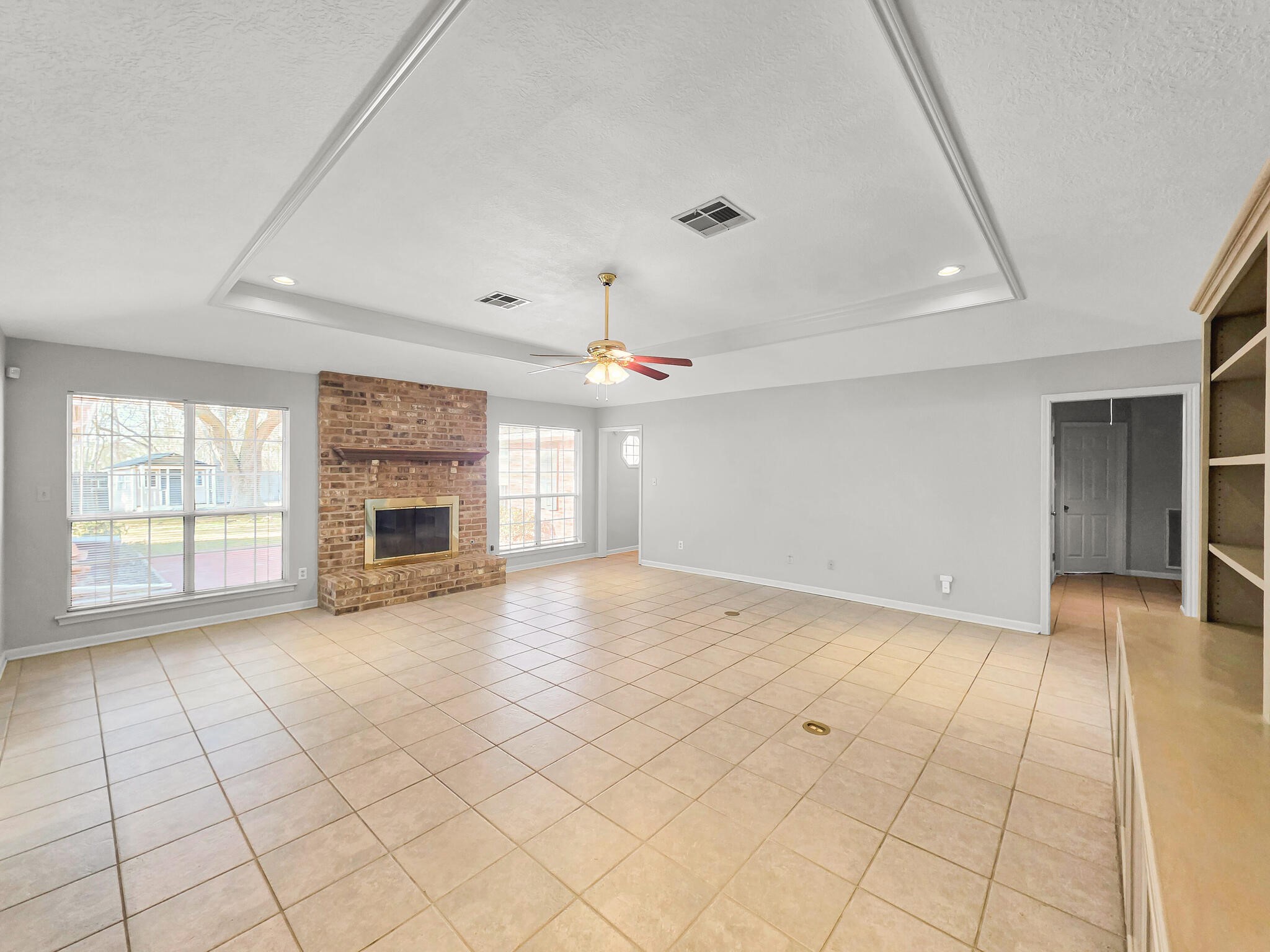 3910 Cypress Point Beaumont, TX 77707 - Photo 23 of 50 an empty room with fireplace and windows