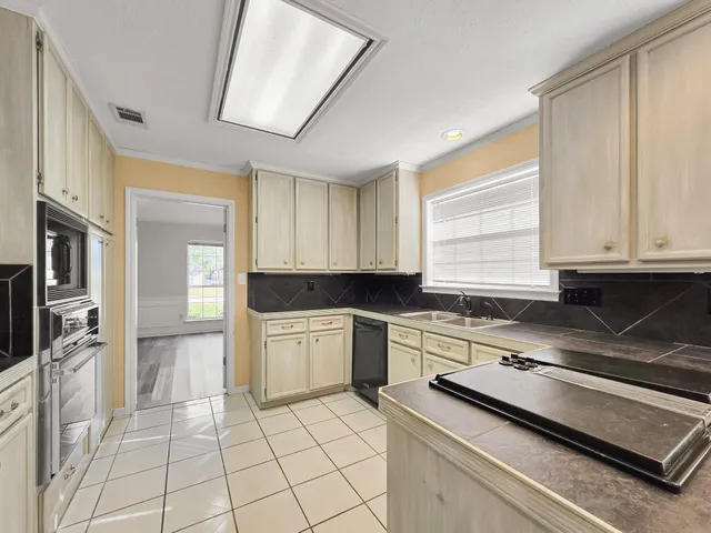 a kitchen with a stove a sink and a refrigerator