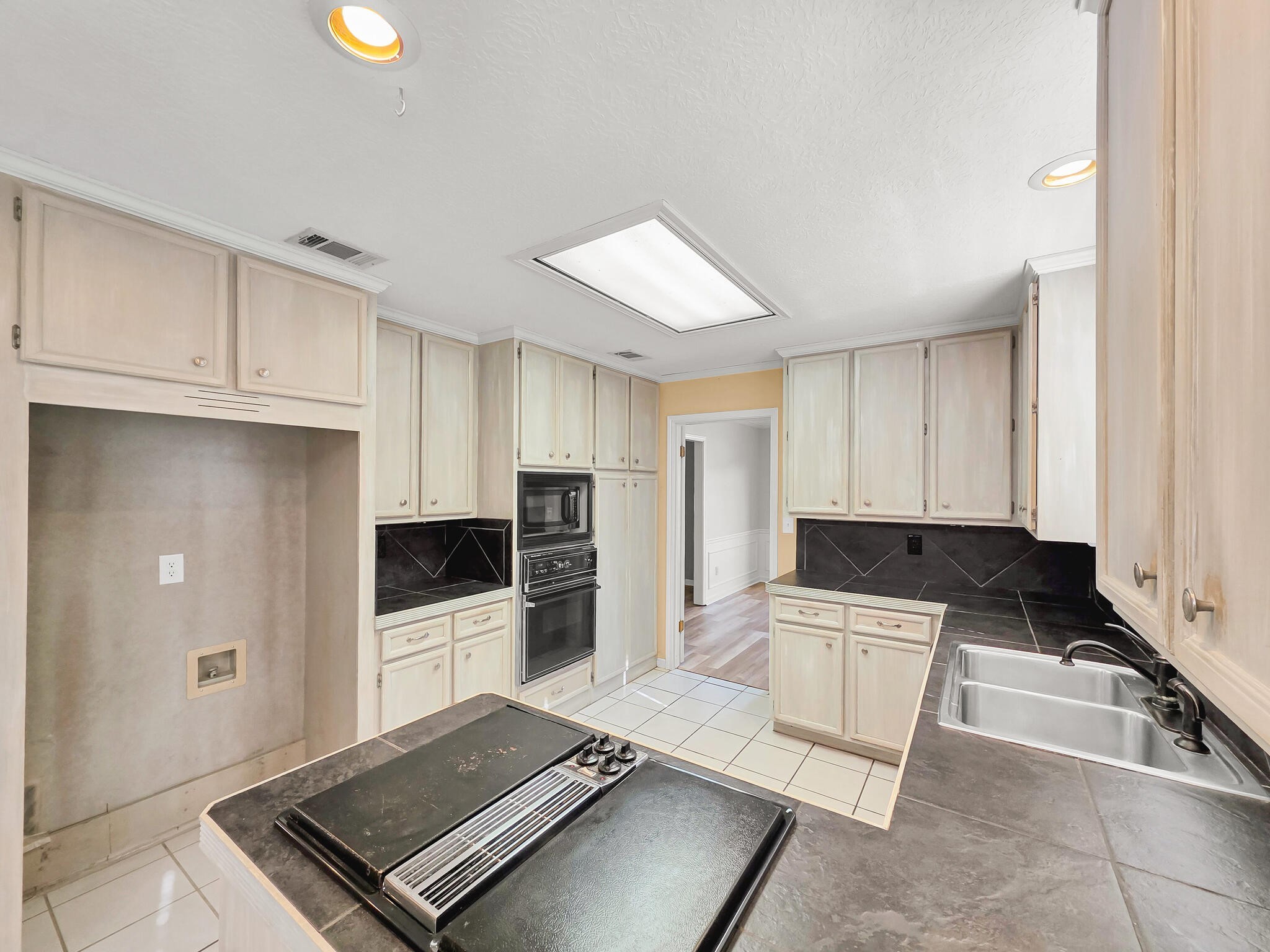 3910 Cypress Point Beaumont, TX 77707 - Photo 29 of 50 a kitchen with granite countertop a refrigerator and a stove top oven