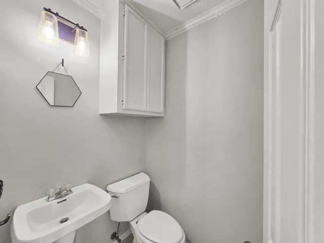 an empty room with windows and chandelier fan