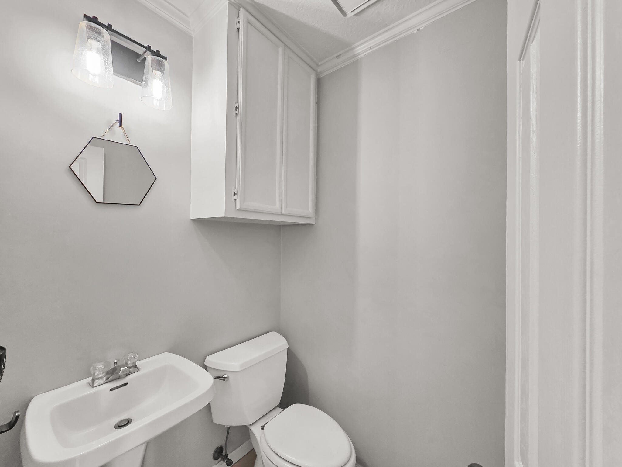 3910 Cypress Point Beaumont, TX 77707 - Photo 49 of 50 a bathroom with a toilet sink and mirror