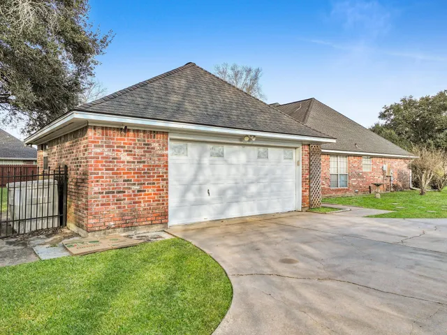 a front view of a house with a garden and yard