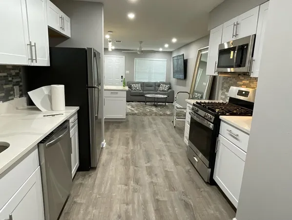a kitchen with stainless steel appliances a refrigerator stove and microwave