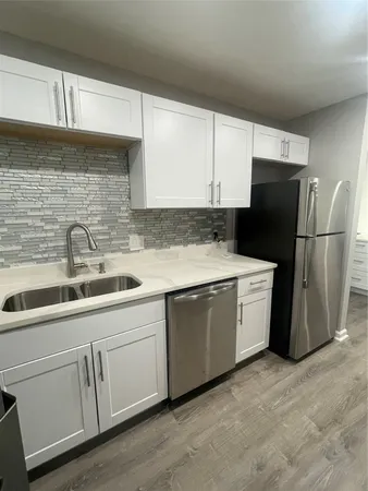 a kitchen with a sink and refrigerator